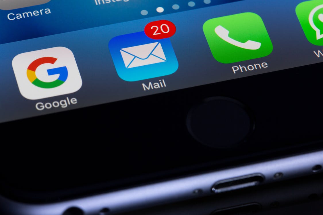 a zoom in of an iPhone showing google, mail, and phone buttons with the number 20 on the mail