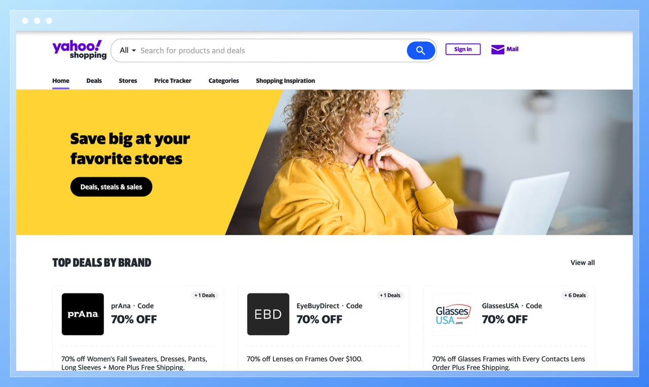 the screenshot of Yahoo Shopping homepage with top deals by brands, a search bar and featuring a curly haired woman working on her laptop