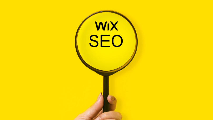 hand holding a magnifying glass on a text that says "Wix SEO"