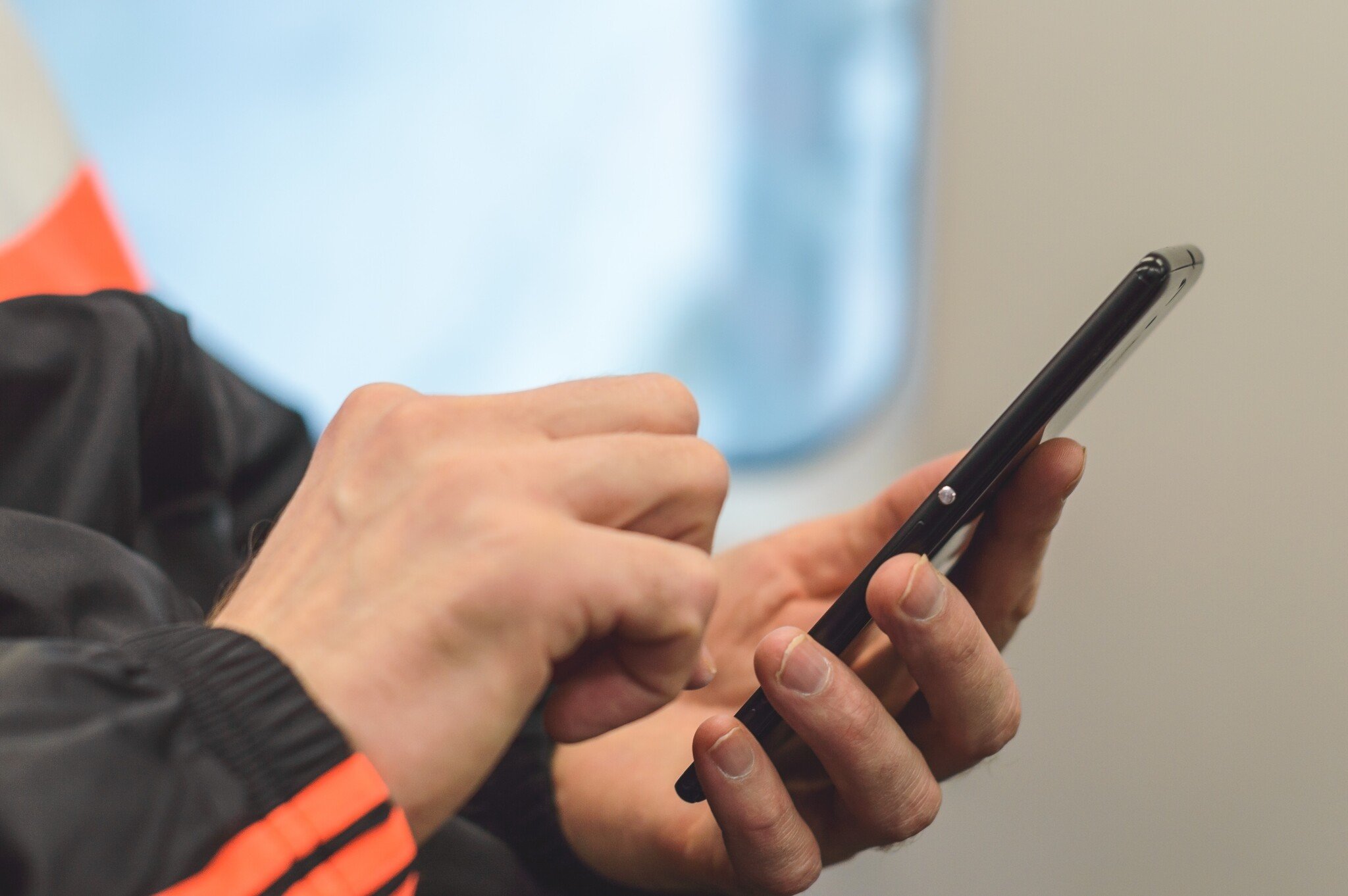 mobile-friendly website optimization as a hand holds and checks a mobile phone
