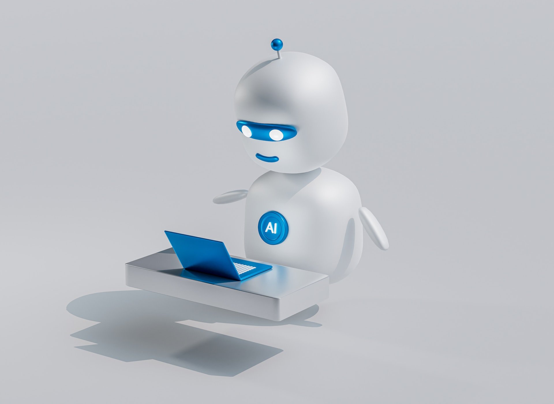 mavi gözlü ve mavi bir dizüstü bilgisayarı olan beyaz bir robot