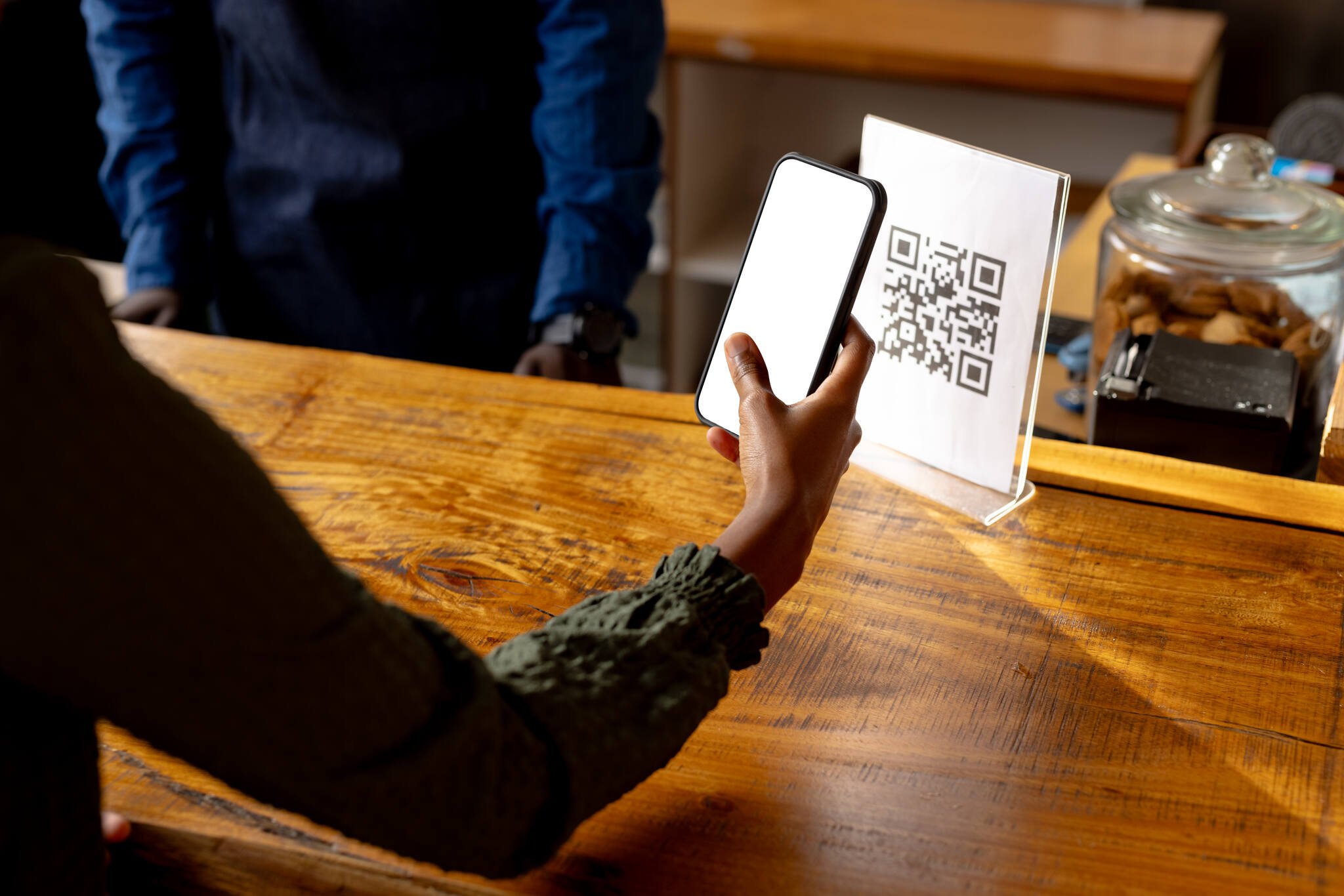 QR code mobile marketing tactic as a woman scans a QR code with her phone
