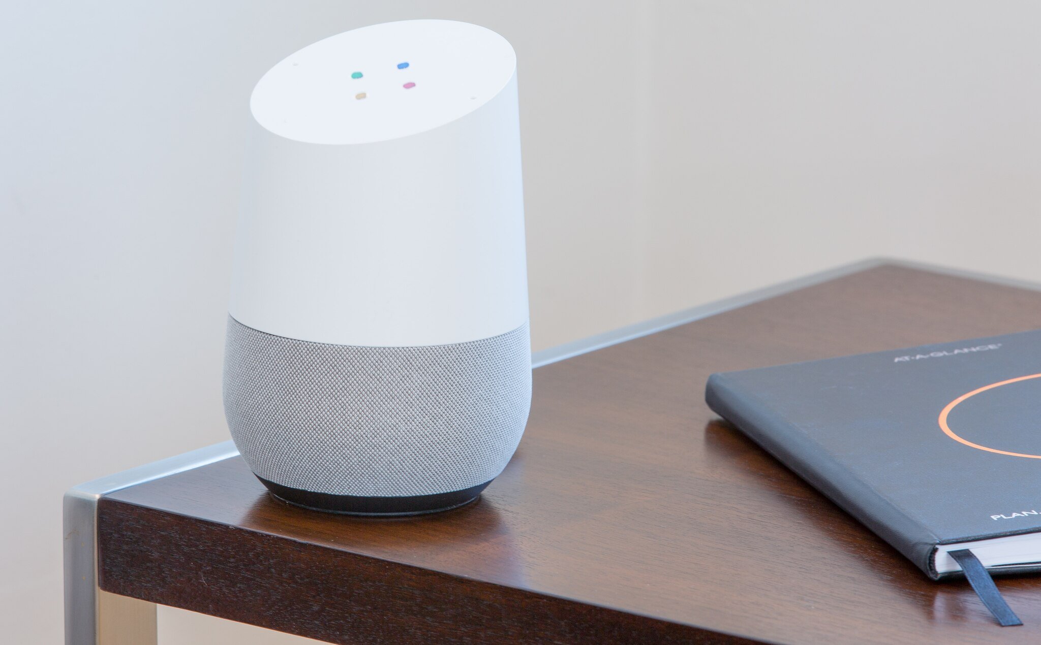 voice search optimization for mobile marketing shown by a Google Assistant speaker on a table next to a notebook