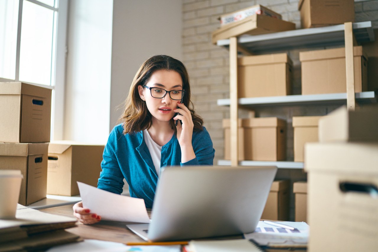 Woman running an ecommerce store from a warehouse workspace
