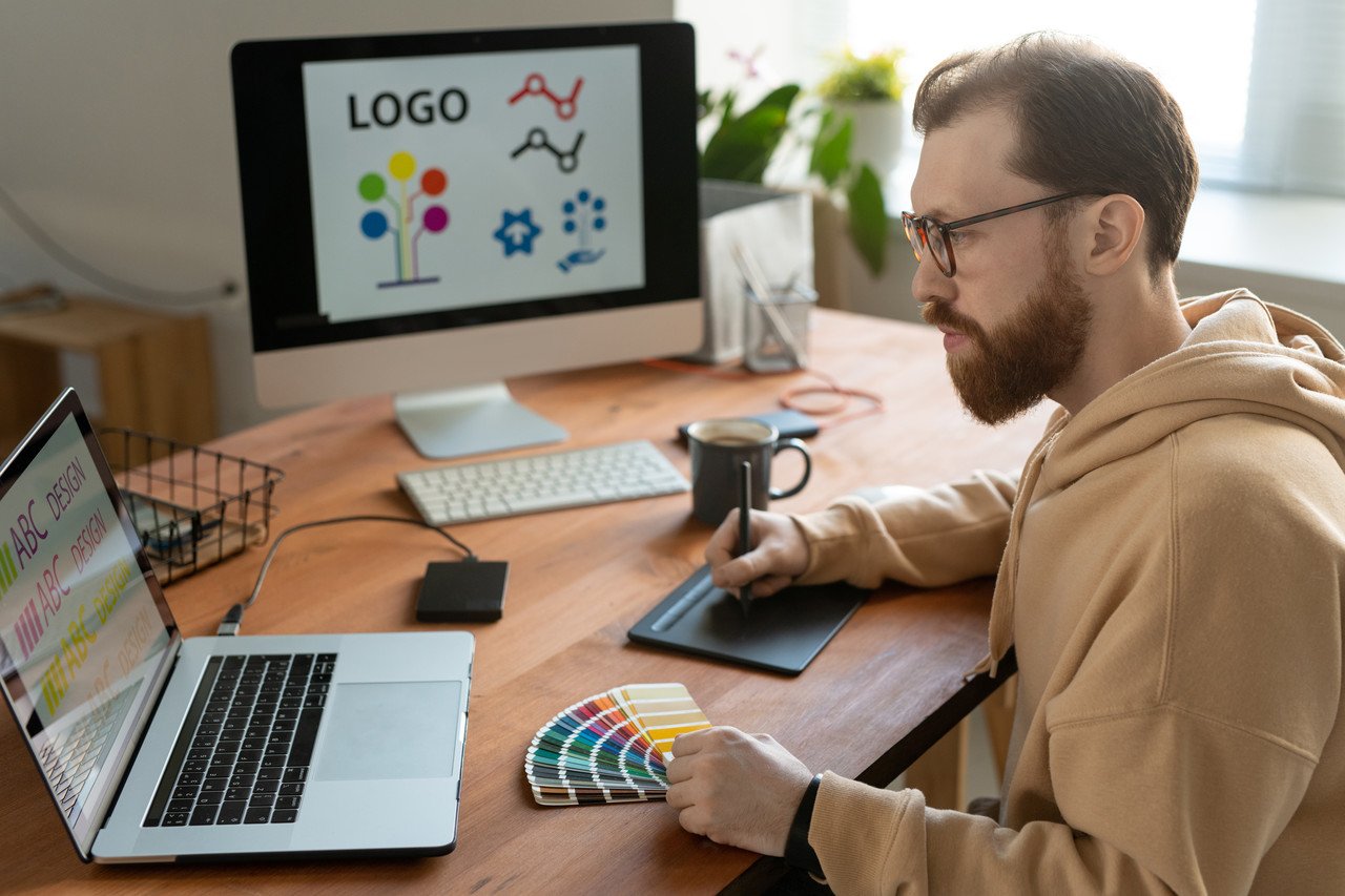 Freelance designer using tablet to manage Shopify service storefront