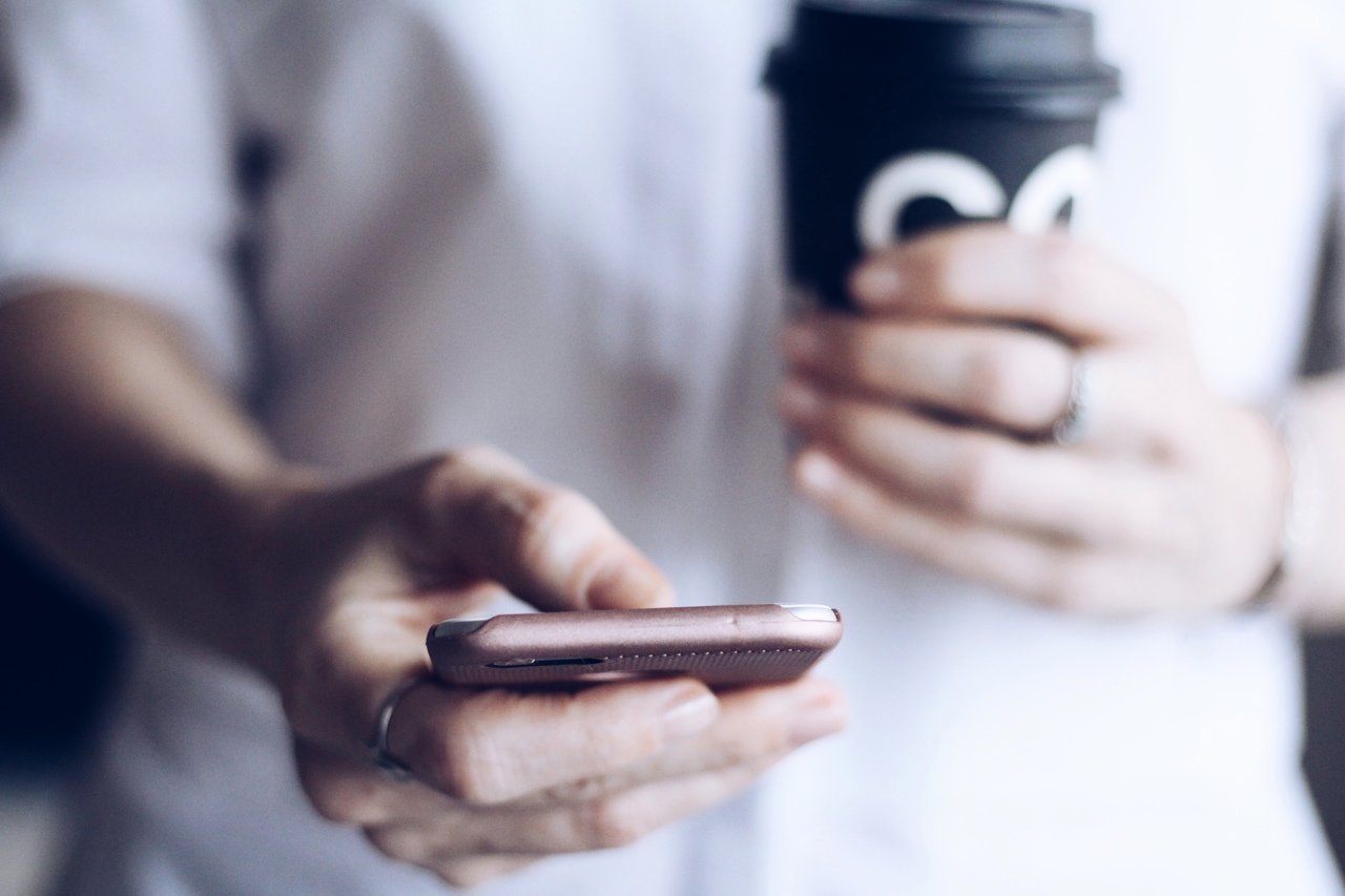 Woman using smartphone for social media selling on Shopify