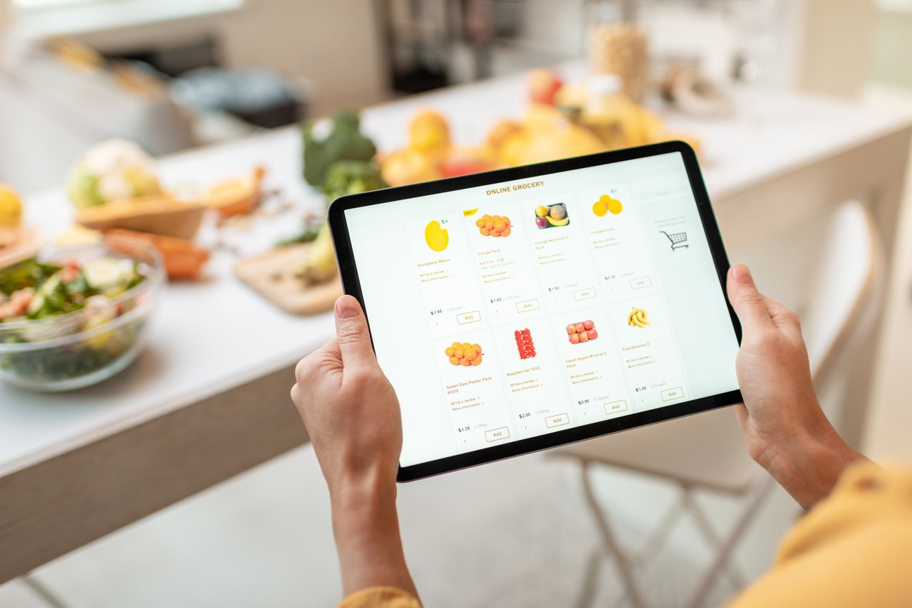 Woman shopping from online grocery store for subscription box items
