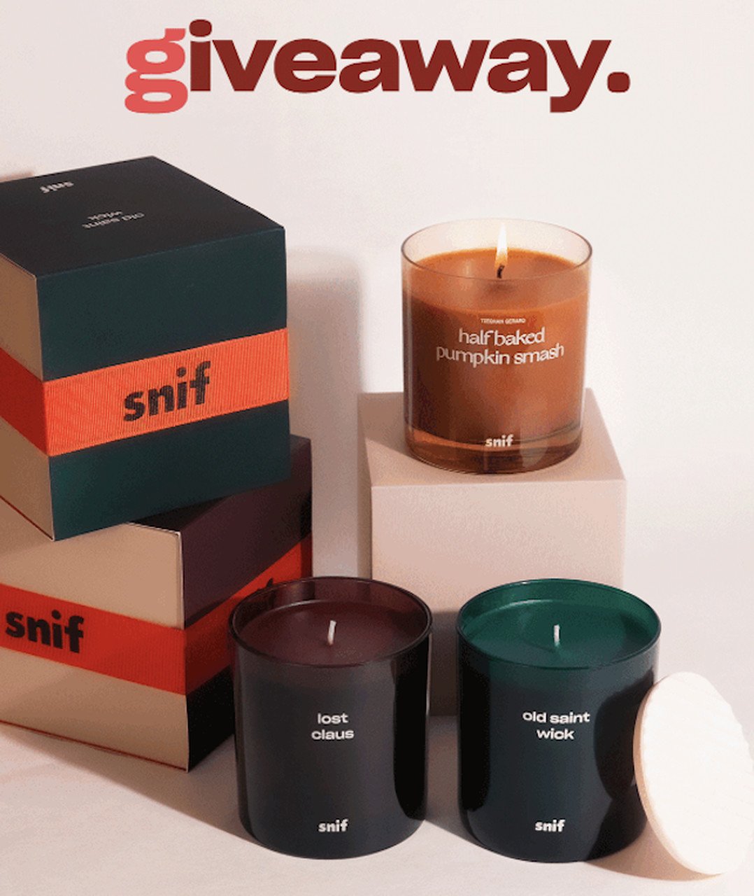 Candles and candle boxes of different colors stacked on light background for giveaway promotion