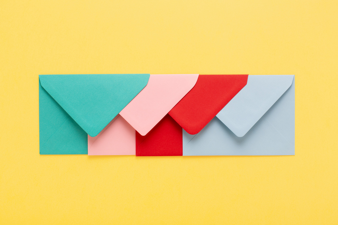 An image shows that four colorful mail on the yellow backround.