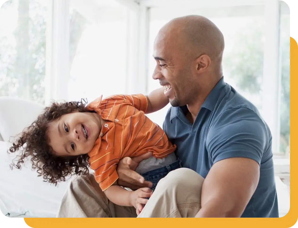 Father laughing with daughter in a smart-home setting enabled by Somfy automation