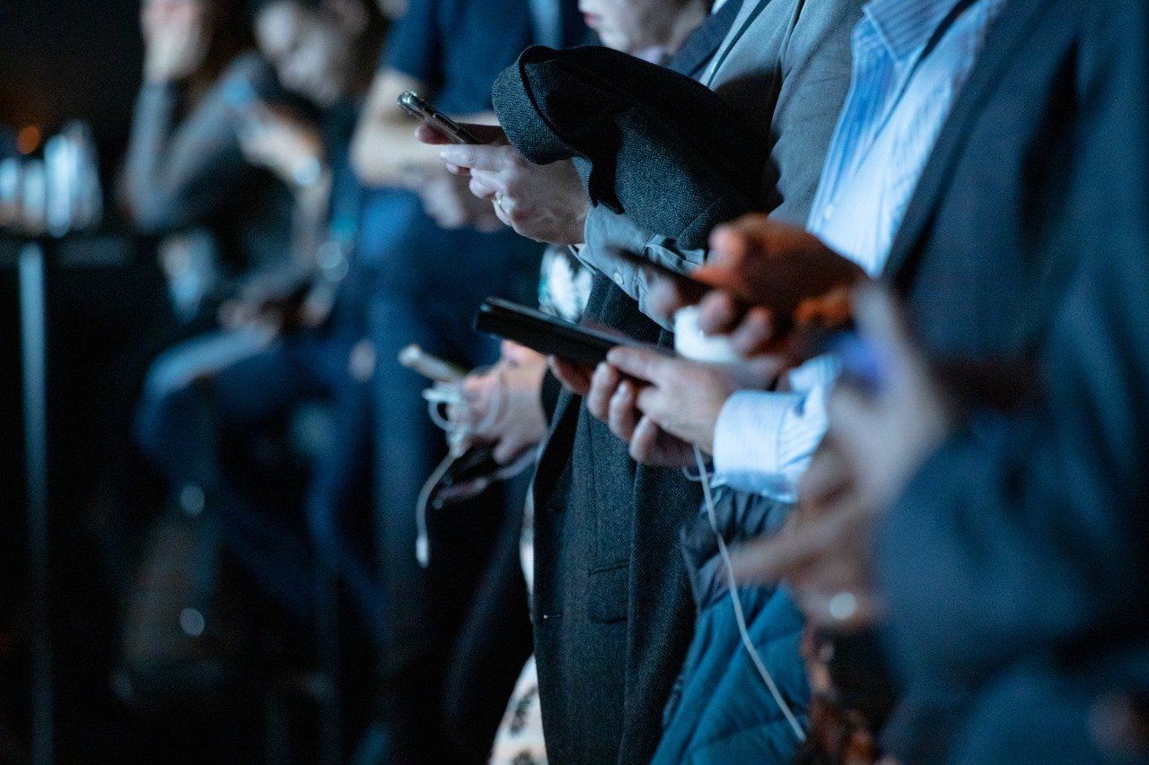 Shoppers using mobile phones for holiday purchases while standing