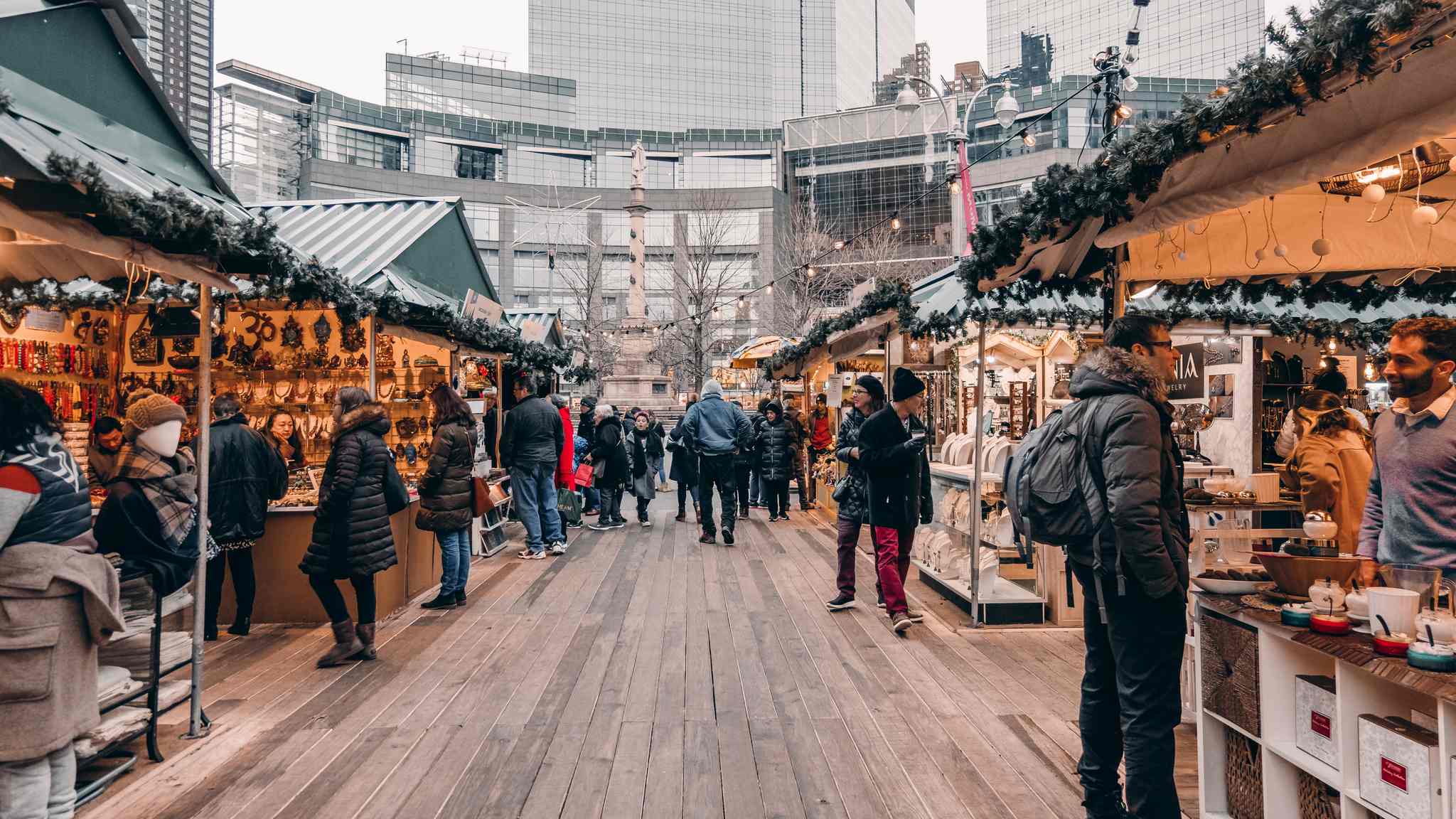 Holiday shoppers at a Christmas market browsing gifts