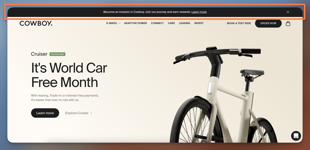 Cowboy electric bike announcement bar displaying community investment for rewards signals