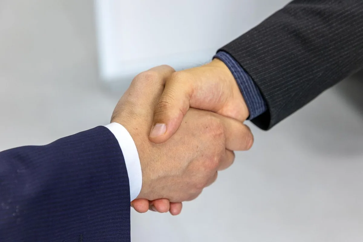 Two professionals shaking hands to build a lasting business relationship